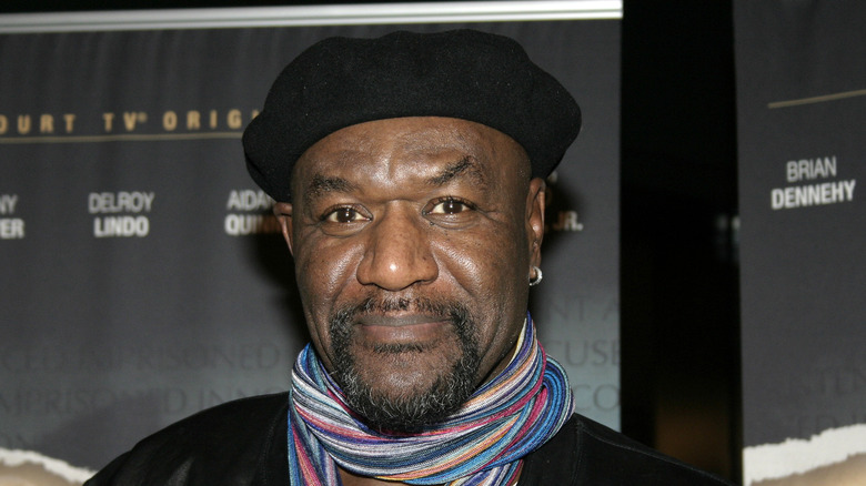 Delroy Lindo on red carpet with scarf and hat