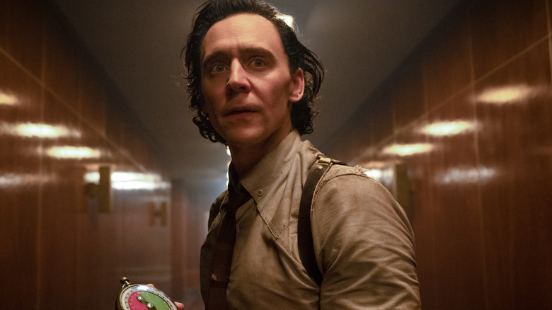 Loki holding a device