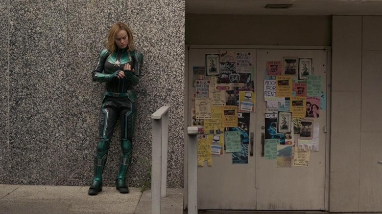 Captain Marvel standing in front of wall