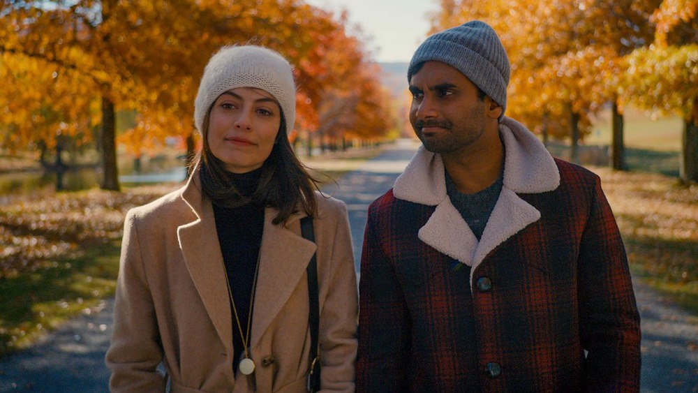 Aziz Ansari and Alessandra Mastronardi walking in the fall