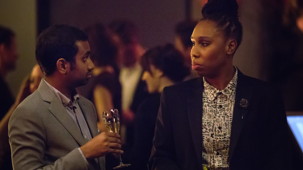 Aziz Ansari and Lena Waithe converse at a party