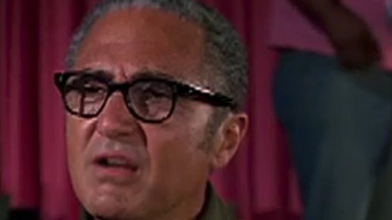 Matlock Sheldon Leonard, wearing glasses, listens