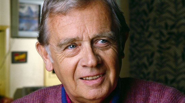 Warren Frost smiles, looks right