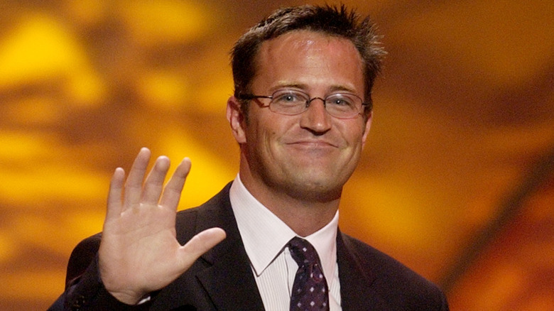 Matthew Perry waving hand