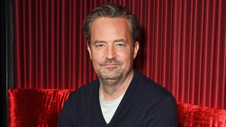 Matthew Perry stubble red background