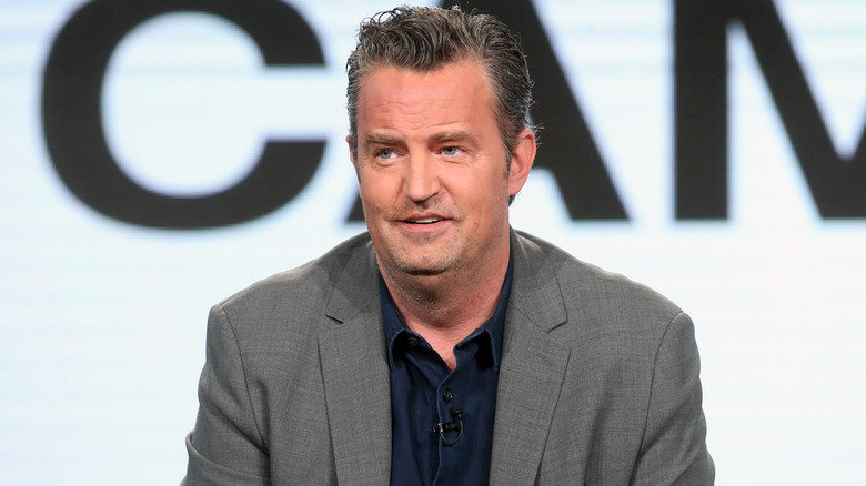 Matthew Perry in grey suit