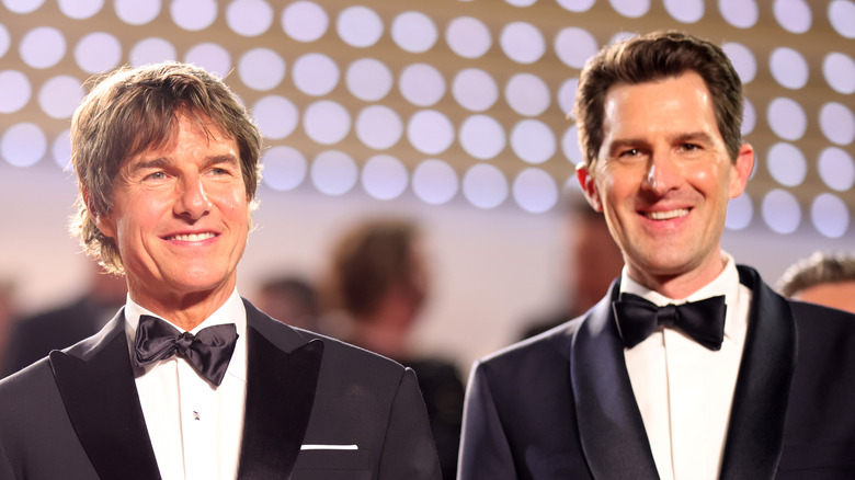 Tom Cruise at event smiling with Joseph Kosinski - both dressed in tuxedos