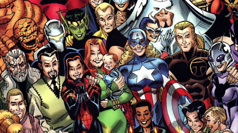 Spider-Girl standing with her family and fellow heroes