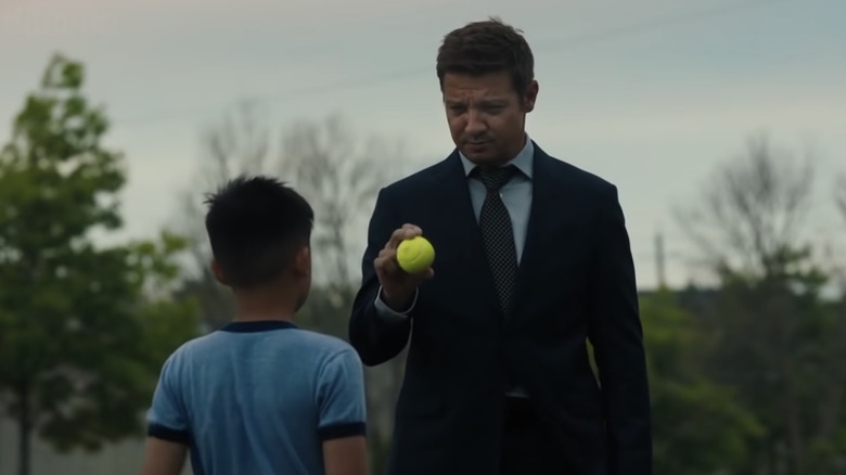 Mike McLusky giving a kid a tennis ball