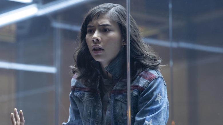 Gomez as America Chavez in a glass cage