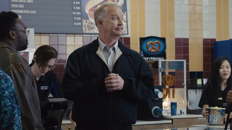 Dr. Rick talking in a movie theatre lobby