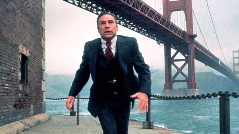 Mel Brooks running underneath bridge