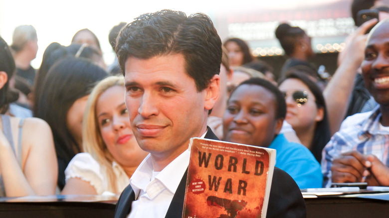 Max Brooks holds up book