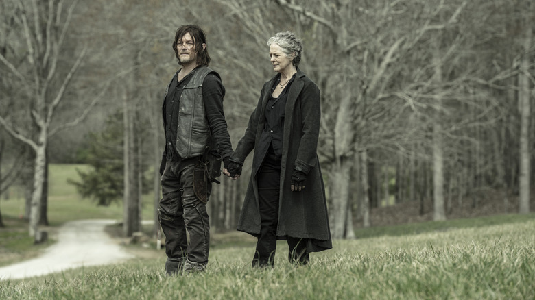 Daryl and Carol holding hands