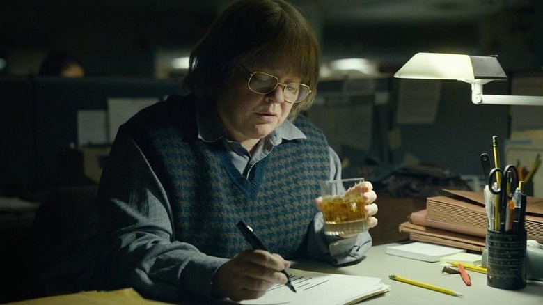 Melissa McCarthy writing with drink 