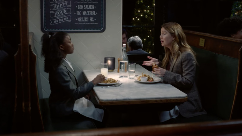 Meredith and Zola talking over dinner