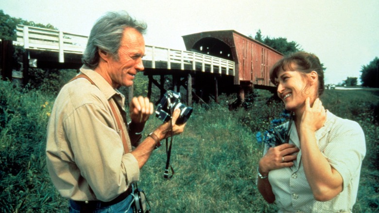 Eastwood holding camera next to Streep