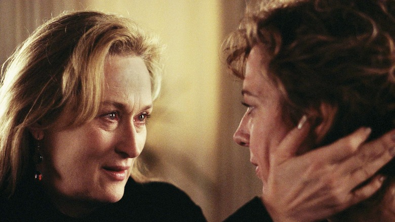 Streep holding Janney's face