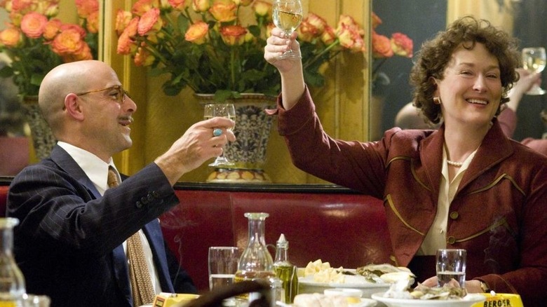 Tucci and Streep raising a toast