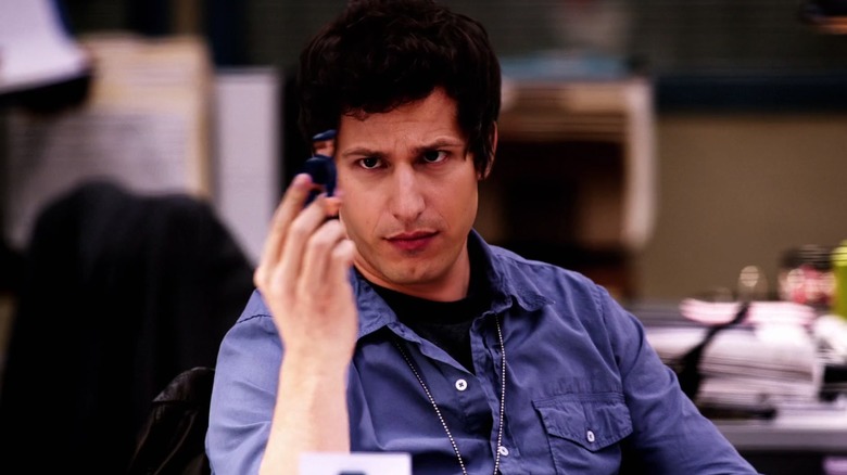 Jake Peralta examines toy