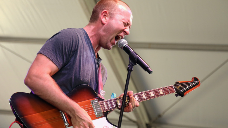 Brendon Small performing with guitar