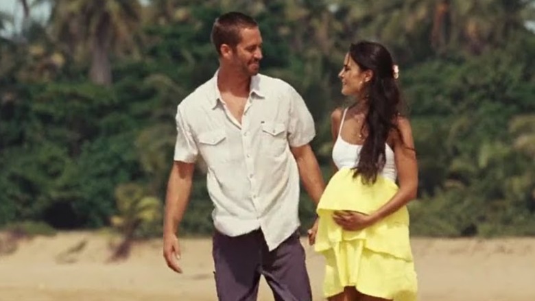 Brian and pregnant Mia on beach