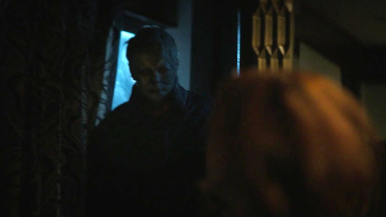 Michael Myers stands in a doorway