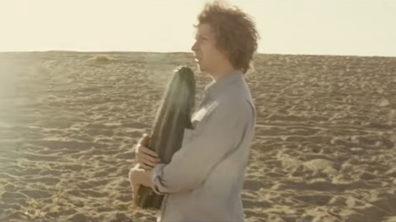 Michael Cera holds a cactus