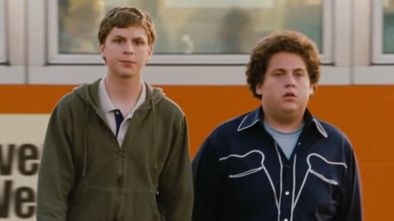 Michael Cera and Jonah Hill walk away from a bus