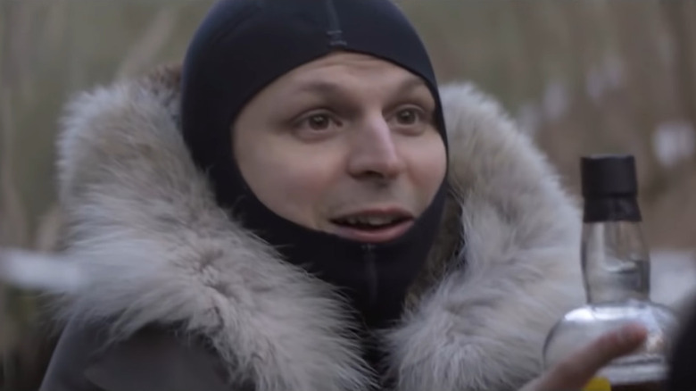 Michael Cera in a ski mask and a fur jacket