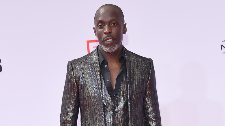 Michael K. Williams posing in suit