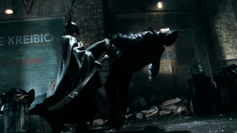 Batman kicking goon