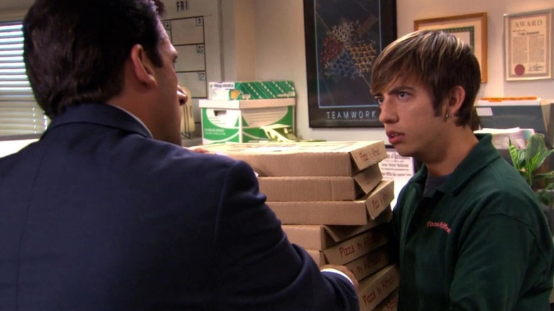 Michael holds the pizza boy hostage