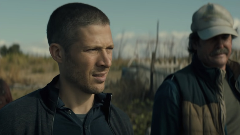 Zach Gilford and Henry Thomas on a beach