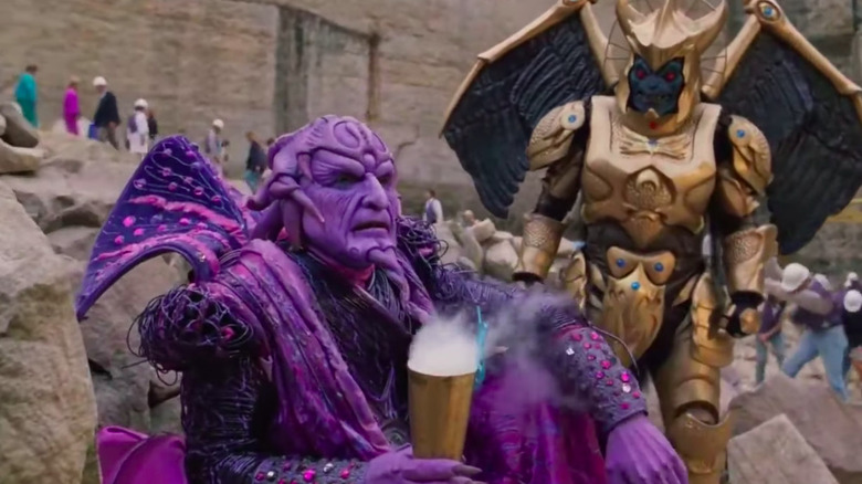 Ivan Ooze holds a smoking goblet while Goldar looks on