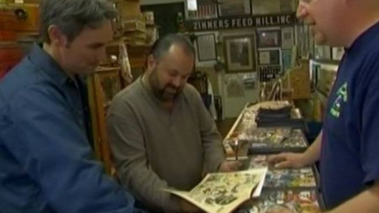 Mike Wolfe looking at a comic book