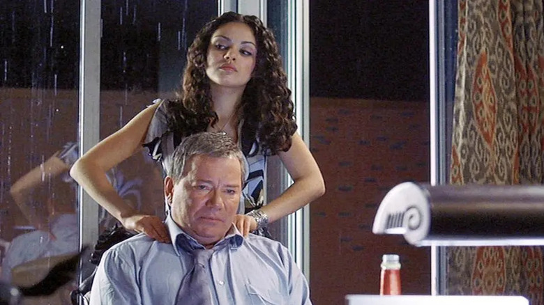 Mila Kunis massaging William Shatner's shoulders