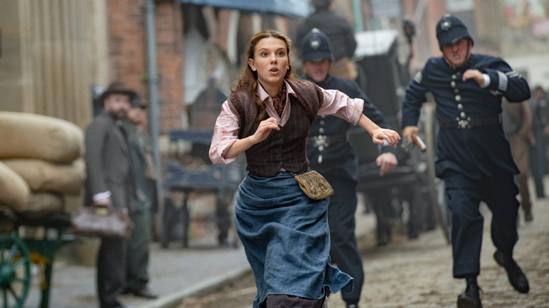 Enola Holmes fleeing from the police in Enola Holmes 2