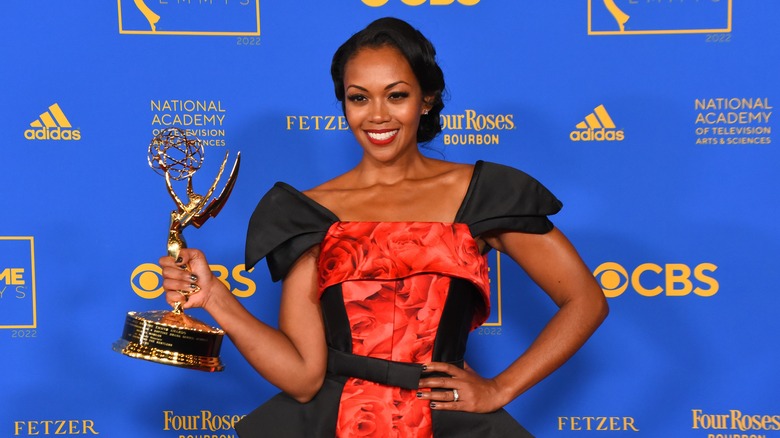 Mishael Morgan holding her Emmy