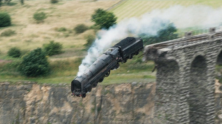 A train speeds off a bridge