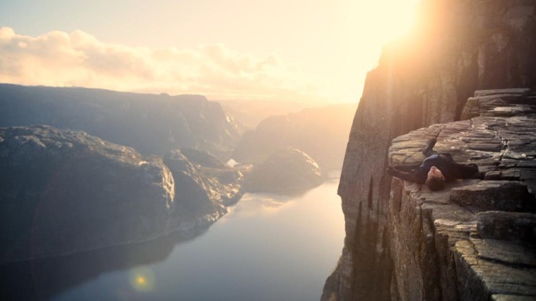 Ethan lays on edge of cliff