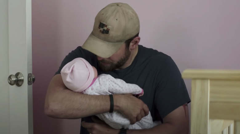 Chris Kyle holding fake baby 
