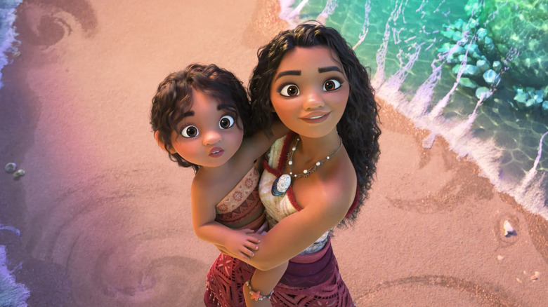 Moana holding her little sister on the beach (2024)