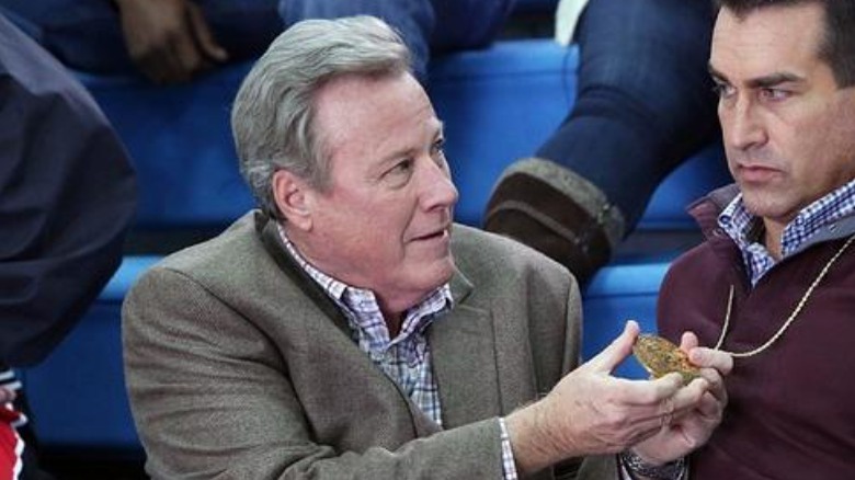 John Heard holding a medal