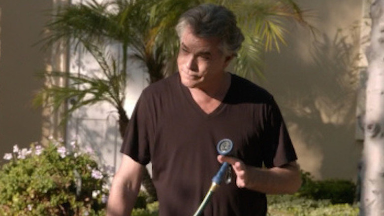 Ray Liotta holds a hose