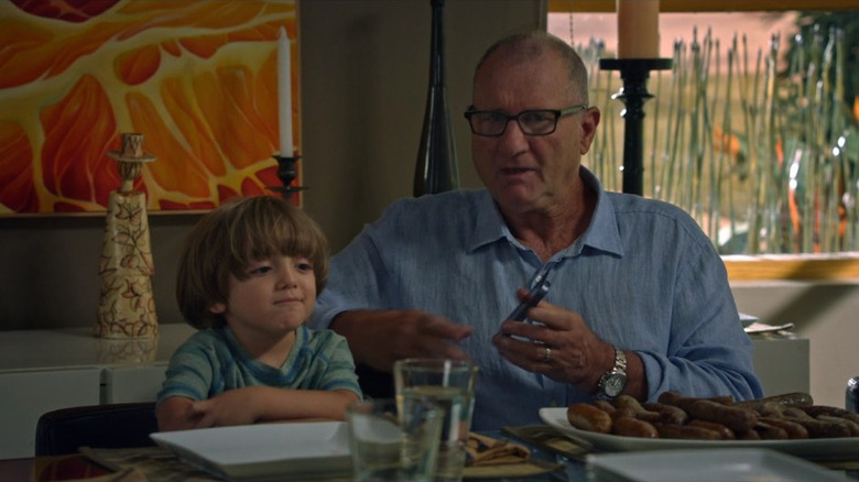 Joe and Jay Pritchett looking at a phone on Modern Family