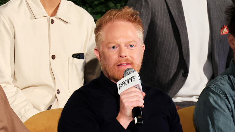 Jesse Tyler Ferguson speaking into a microphone