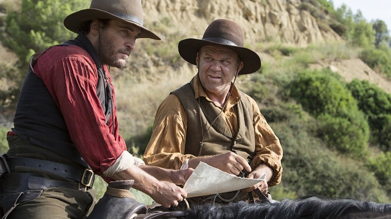 Charlie and Eli Sisters consult a map while on horseback