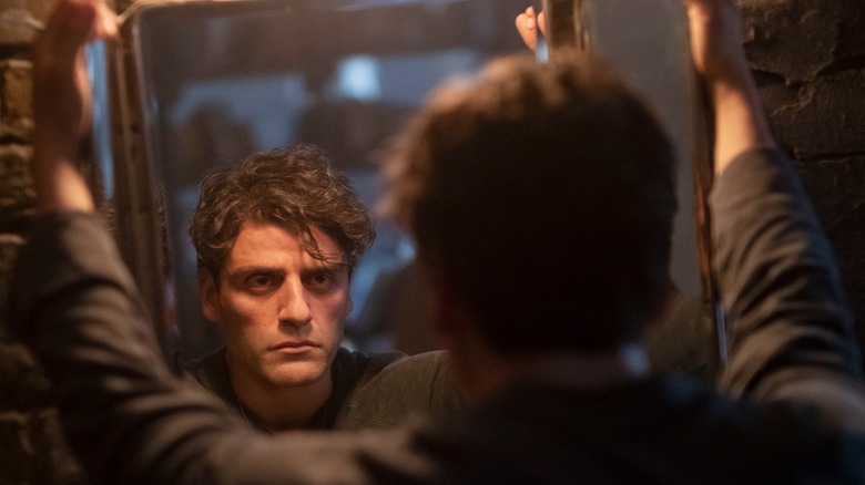 Oscar Isaac looking in the mirror in "Moon Knight"