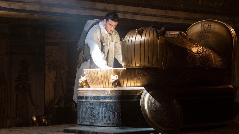 Oscar Isaac opening a sarcophagus
